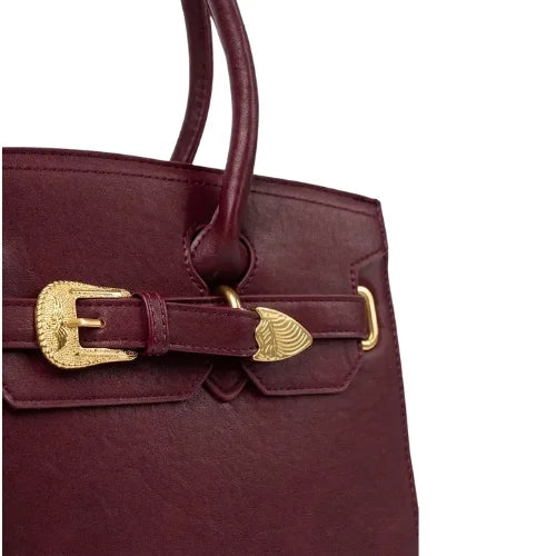 Burgundy handbag with decorative gold buckle